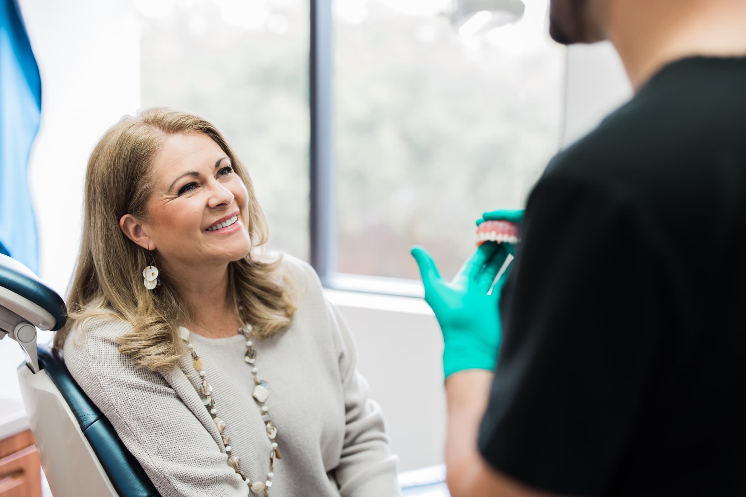 Dr. Ryan Trevino consulting with a patient about veneers at RealVeneers in Sugar Land, TX